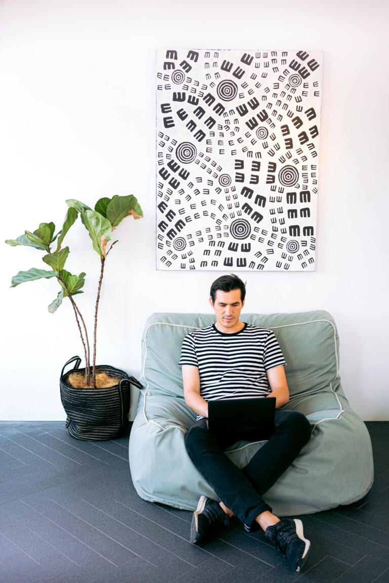 Man Sitting Cozy While Working on his Laptop