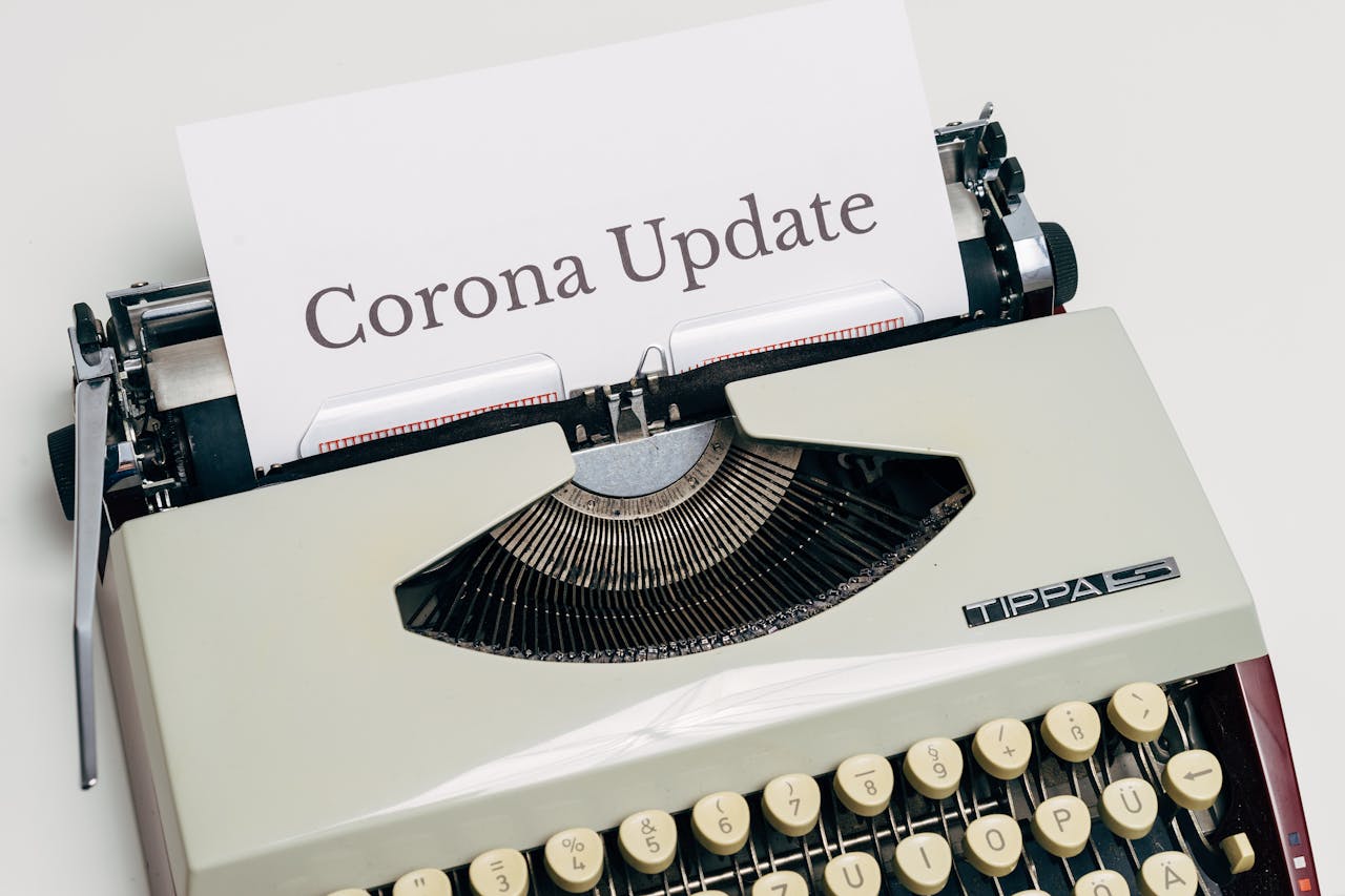 A Vintage Typewriter With Corona Update Typed On White Paper